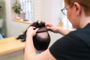 Capillary Clinic Expert Applies Natural Hair Prosthesis to Client